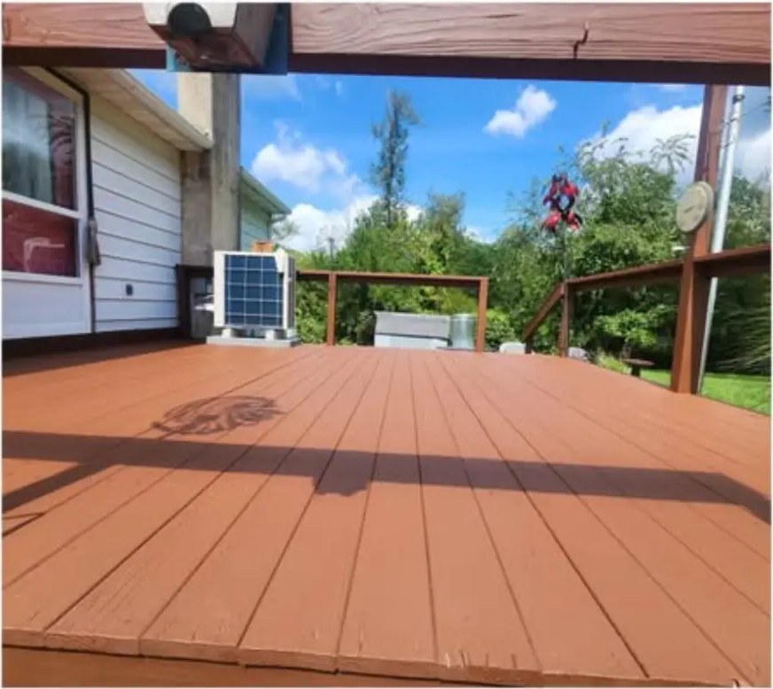 After deck staining: warm reddish-brown boards near an HVAC unit